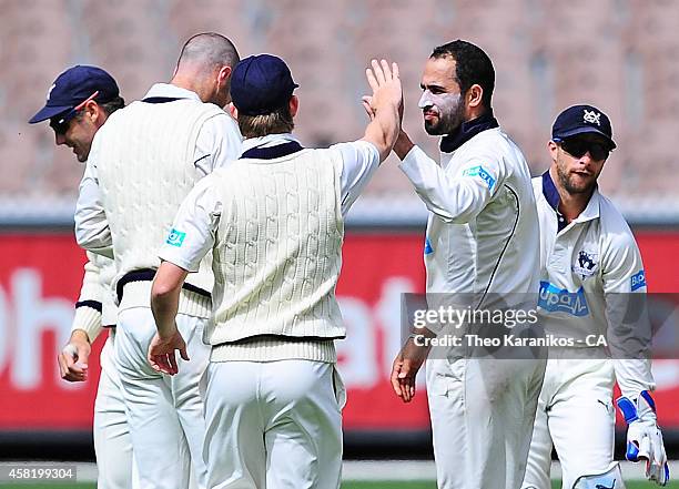 Fawad Ahmed of the Bushrangers is congratulated by teammates after taking the wicket of Will Somerville of the Blues during day two of the Sheffield...