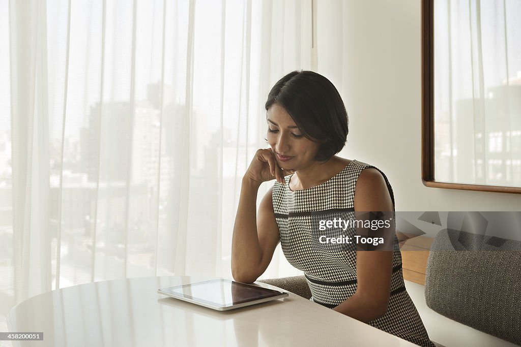 Professional Woman reading digital tablet