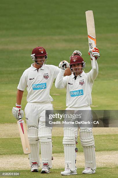 Nick Stevens of the Bulls congratulate teammate Chris Hartley after Hartley reached 100 runs during day two of the Sheffield Shield match between...