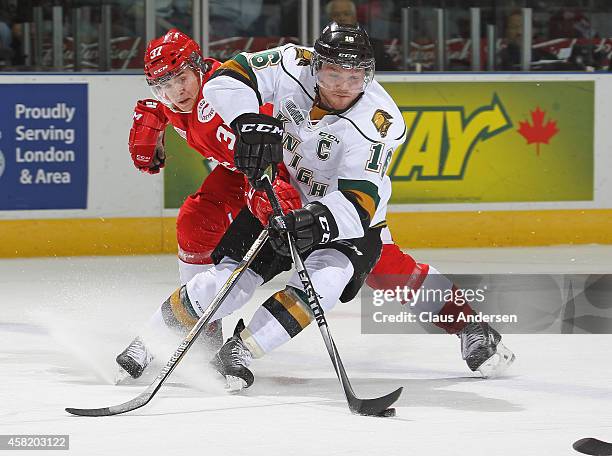 Gustav Bouramman of the Sault Ste. Marie Greyhounds tries to check a breaking Max Domi of the London Knights in an OHL game at the Budweiser Gardens...