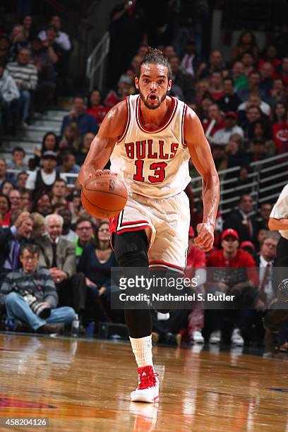 Joakim Noah of the Chicago Bulls handles the ball against the Cleveland Cavaliers during a game at the United Center on October 31, 2014 in Chicago,...