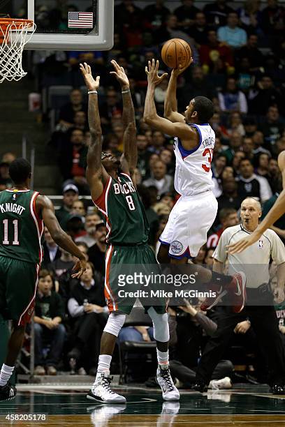 Hollis Thompson of the Philadelphia 76ers drives to the hoop for two points against Larry Sanders of the Milwaukee Bucks during the second half at...