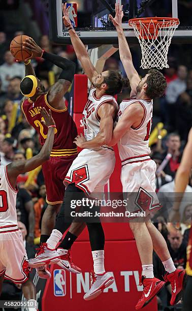 LeBron James of the Cleveland Cavaliers puts up a shot against Joakim Noah and Pau Gasol of the Chicago Bulls at the United Center on October 31,...