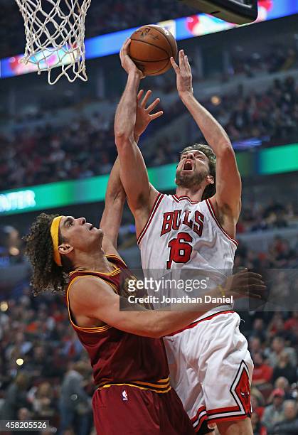 Pau Gasol of the Chicago Bulls shoots over Anderson Varejao of the Cleveland Cavaliers at the United Center on October 31, 2014 in Chicago, Illinois....