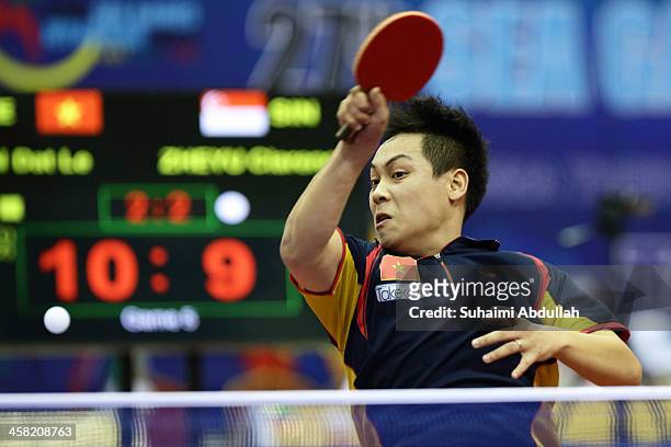 Tien Dat Le of Vietnam hits a return to Chew Zheng Yu Clarence of Singapore during the men's semi-final table tennis match at Wunna Theikdi Indoor...