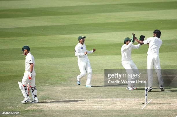 David Waner of Australia leaves the pitch after he is caught by Yasir Shah of Pakistan off the bowling of Rahat Ali during Day Three of the Second...