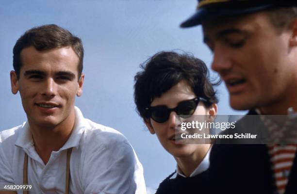 Portrait of American actors Dean Stockwell and Millie Perkins, along with Stockwell's older brother, fellow actor Guy Stockwell , on a boat, Newport...