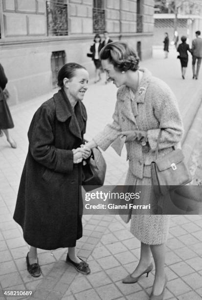 The Belgian Queen Fabiola is greeted by an old lady Madrid, Spain. .