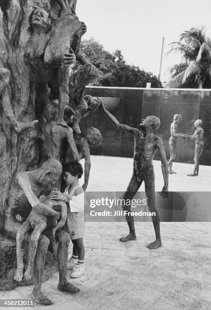 Young girl inspects the sculpture in the 'Garden of Meditation' at the Holocaust Memorial, Miami Beach, United States, 1994.