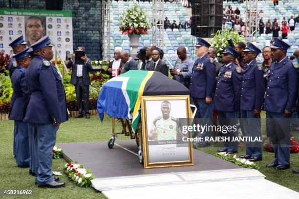 Members of the South African Police Services stand guard at the coffin of Senzo Meyiwa in front of thousands of South Africans who gather at the...