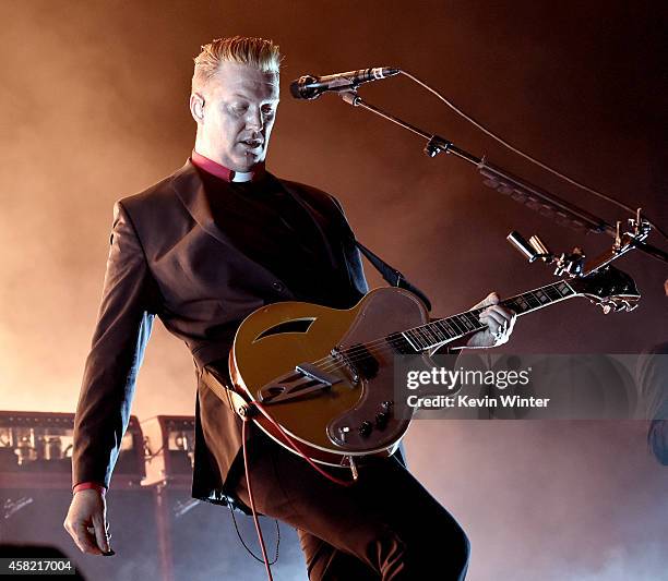 Musician Josh Homme of Queens of The Stone Age performs at the Forum on October 31, 2014 in Inglewood, California.