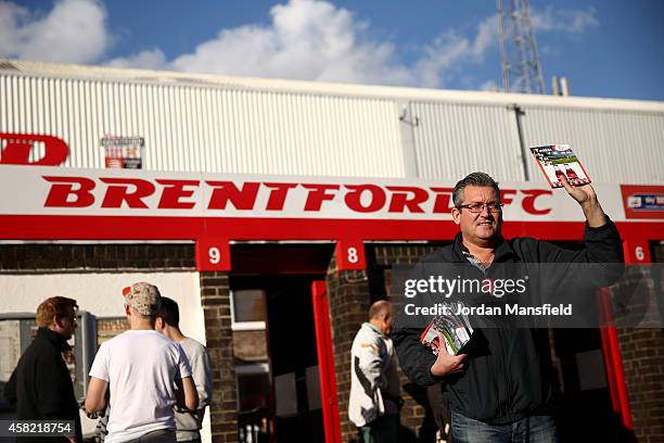 Programme seller holds a fanzine prior during the Sky Bet Championship match between Brentford and Derby County at Griffin Park on November 1, 2014...