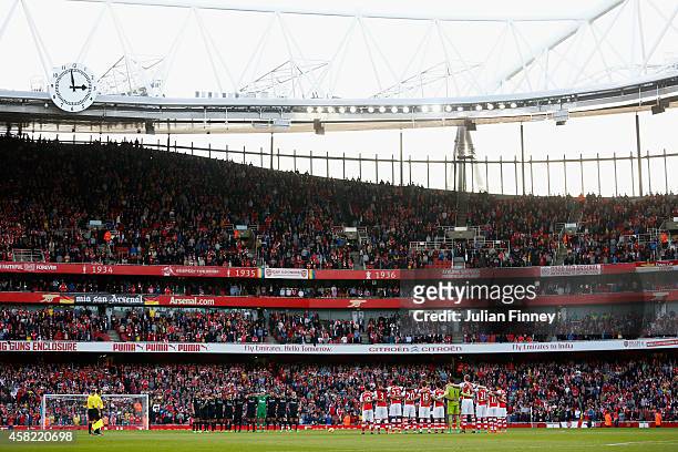 Players observe a one minute silence before the Barclays Premier League match between Arsenal and Burnley at Emirates Stadium on November 1, 2014 in...