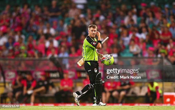 David Warner of the Thunder walks from the field after being dismissed during the Big Bash League match between the Sydney Sixers and Sydney Thunder...