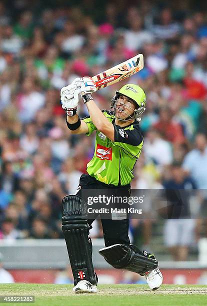 David Warner of the Thunder hits for six during the Big Bash League match between the Sydney Sixers and Sydney Thunder at SCG on December 21, 2013 in...