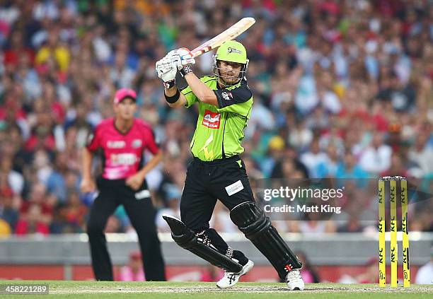 David Warner of the Thunder plays a cut shot during the Big Bash League match between the Sydney Sixers and Sydney Thunder at SCG on December 21,...