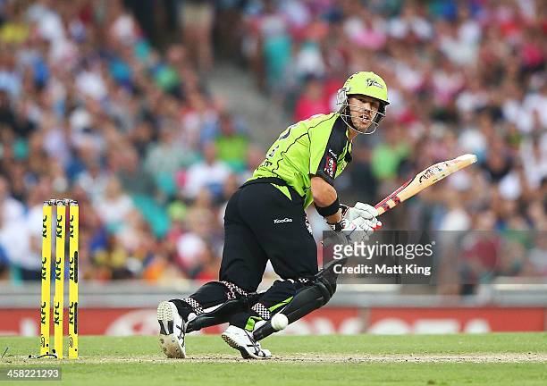 David Warner of the Thunder plays on the leg side during the Big Bash League match between the Sydney Sixers and Sydney Thunder at SCG on December...