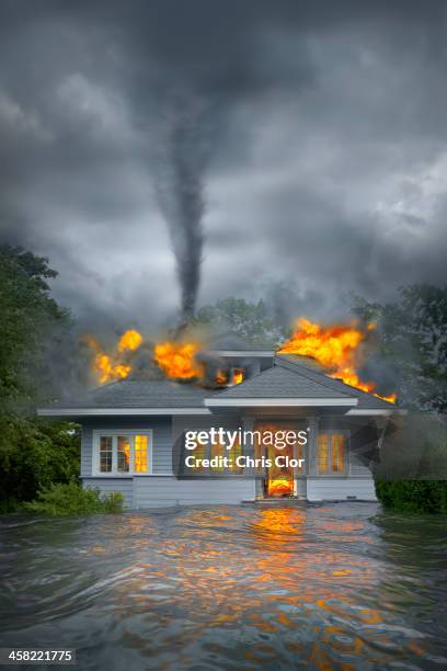 burning house under tornado in flooded landscape - burning house stock pictures, royalty-free photos & images