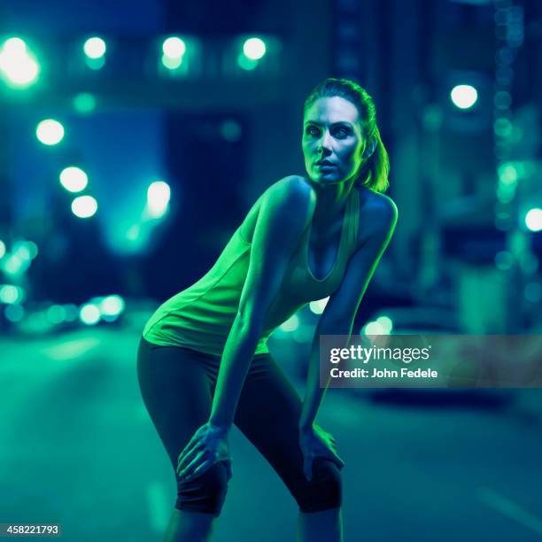 caucasian runner standing on city street - imagen virada fotografías e imágenes de stock