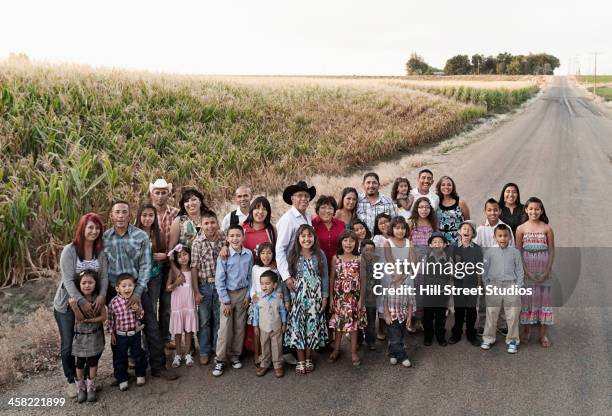 family smiling together on rural road - large family ストックフォトと画像