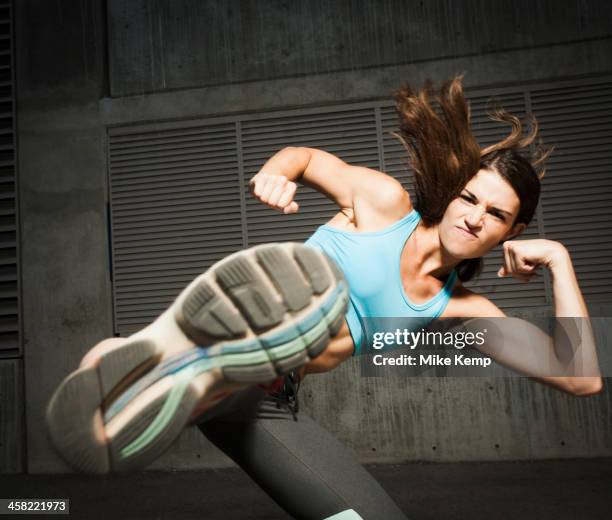 caucasian woman kicking - fast furious stock pictures, royalty-free photos & images