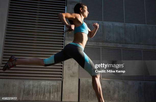 caucasian woman running - striding stock pictures, royalty-free photos & images
