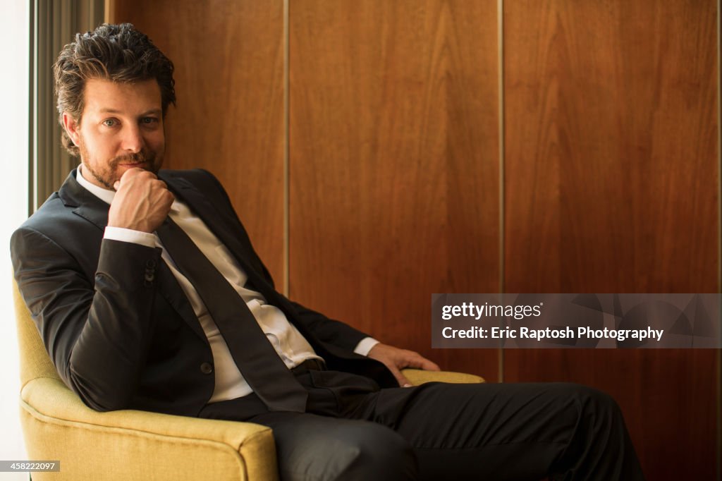 Caucasian businessman sitting in armchair