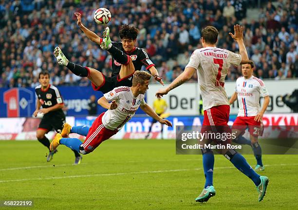 Matthias Ostrzolek of Hamburg and Heung Min Son of Leverkusen battle for the ball during the Bundesliga match between Hamburger SV and Bayer 04...