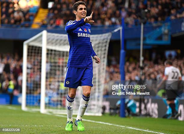 Oscar of Chelsea celebrates scoring the opening goal during the Barclays Premier League match between Chelsea and Queens Park Rangers at Stamford...