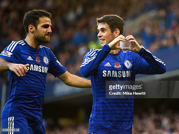 Oscar of Chelsea celebrates his goal with Cesc Fabregas during the Barclays Premier League match between Chelsea and Queens Park Rangers at Stamford...