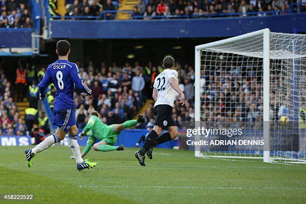 Chelsea's Brazilian midfielder Oscar scores the opening goal during the English Premier League football match between Chelsea and Queens Park Rangers...