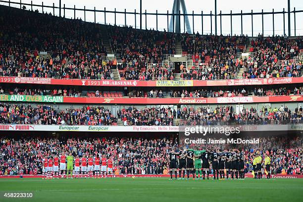 Players and fans observe a one minute silence before the Barclays Premier League match between Arsenal and Burnley at Emirates Stadium on November 1,...