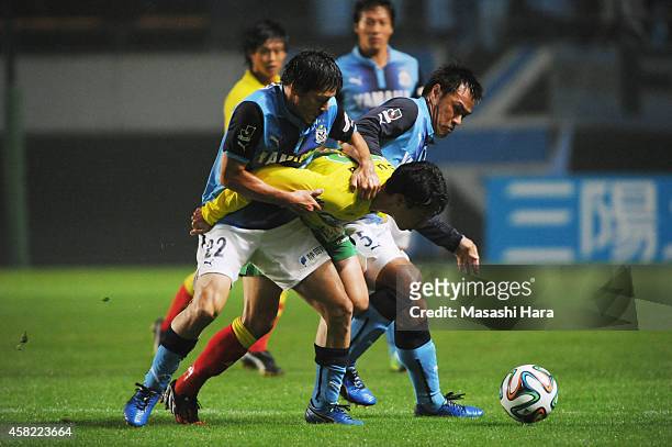Shuto Kono of JEF United Chiba and Yuichi Komano and Daisuke Matsui of Jubilo Iwata compete for the ball during the J.League second division match...