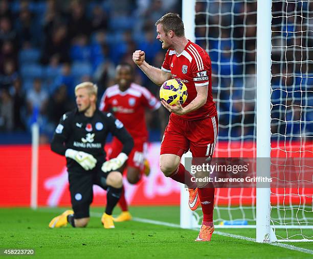 Chris Brunt of West Brom celebrates as he picks the matchball up from the net after Esteban Cambiasso of Leicester City scored an own goal during the...