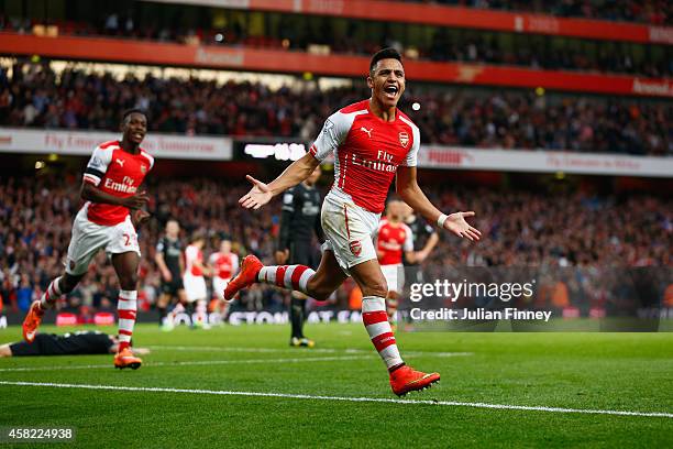 Alexis Sanchez of Arsenal celebrates scoring the first goal for Arsenal during the Barclays Premier League match between Arsenal and Burnley at...