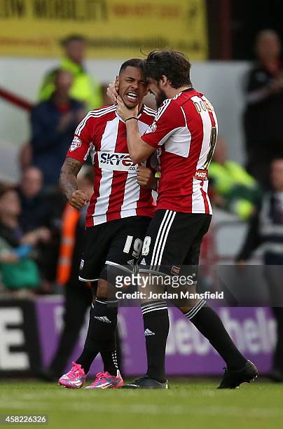 Andre Gray of Brentford celebrates with Jonathan Douglas of Brentford after he scores to make it 1-1 during the Sky Bet Championship match between...