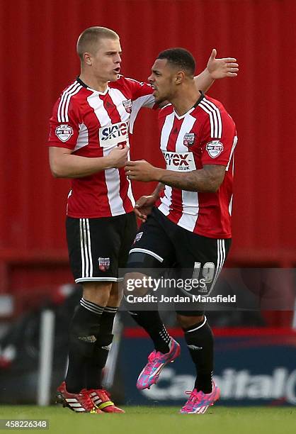 Andre Gray of Brentford celebrates with Jake Bidwell of Brentford after he scores to make it 1-1 during the Sky Bet Championship match between...