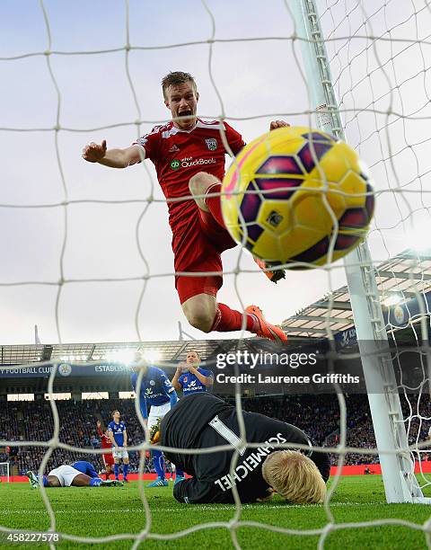 Chris Brunt of West Brom celebrates as he jumps over Kasper Schmeichel of Leicester City after Esteban Cambiasso of Leicester City scored an own goal...