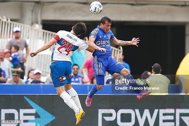 Sebastian Ubilla of Universidad de Chile fights for the ball with Alfonso Parot of Universidad Catolica during a match between Universidad de Chile...
