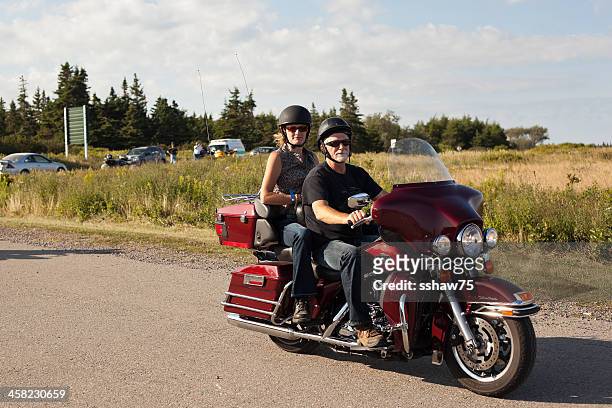 couple on red harley - harley davidson stock pictures, royalty-free photos & images