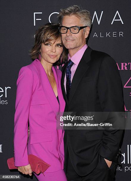 Actors Lisa Rinna and Harry Hamlin arrive at the 10th Annual Pink Party held at Santa Monica Airport on October 18, 2014 in Santa Monica, California.