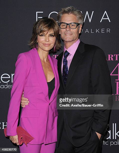 Actors Lisa Rinna and Harry Hamlin arrive at the 10th Annual Pink Party held at Santa Monica Airport on October 18, 2014 in Santa Monica, California.
