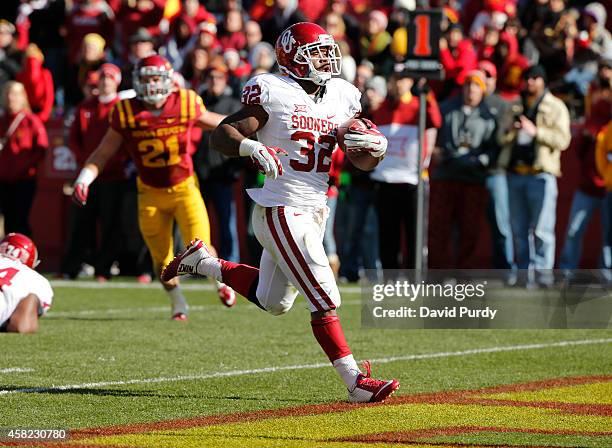 Running back Samaje Perine of the Oklahoma Sooners drives the ball into the end zone for a touchdown as linebacker Luke Knott of the Iowa State...