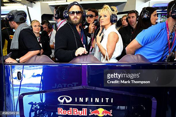 Actress Pamela Anderson and her husband Rick Salomon watch the action in the Infiniti Red Bull Racing garage during qualifying for the United States...