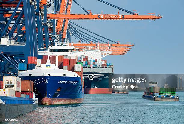 gantry cranes loading cargo container ships in harbor - barge stock pictures, royalty-free photos & images