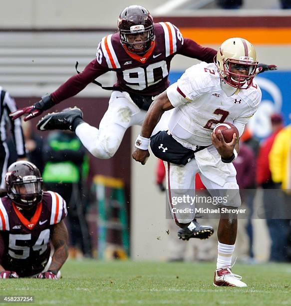 Quarterback Tyler Murphy of the Boston College Eagles rushes down the field while being chased by defensive end Dadi Nicolas of the Virginia Tech...