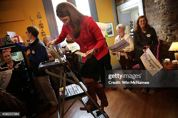 Democratic Senate candidate and Kentucky Secretary of State Alison Lundergan Grimes climbs down from the top of a ladder after speaking to Kentucky...