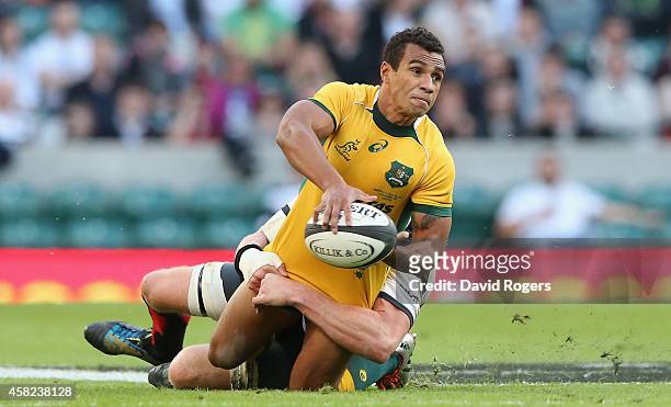 Will Genia of Australia passes the ball as Adam Thomson tackles during the Killick Cup match between the Barbarians and Australian Wallabies at...