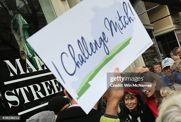 Democratic Senate candidate and Kentucky Secretary of State Alison Lundergan Grimes greets voters while arriving for a campaign stop at the Sixth and...