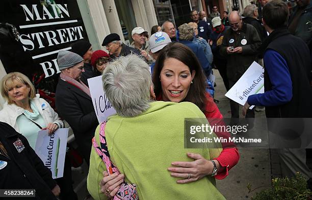 Democratic Senate candidate and Kentucky Secretary of State Alison Lundergan Grimes greets voters while arriving for a campaign stop at the Sixth and...